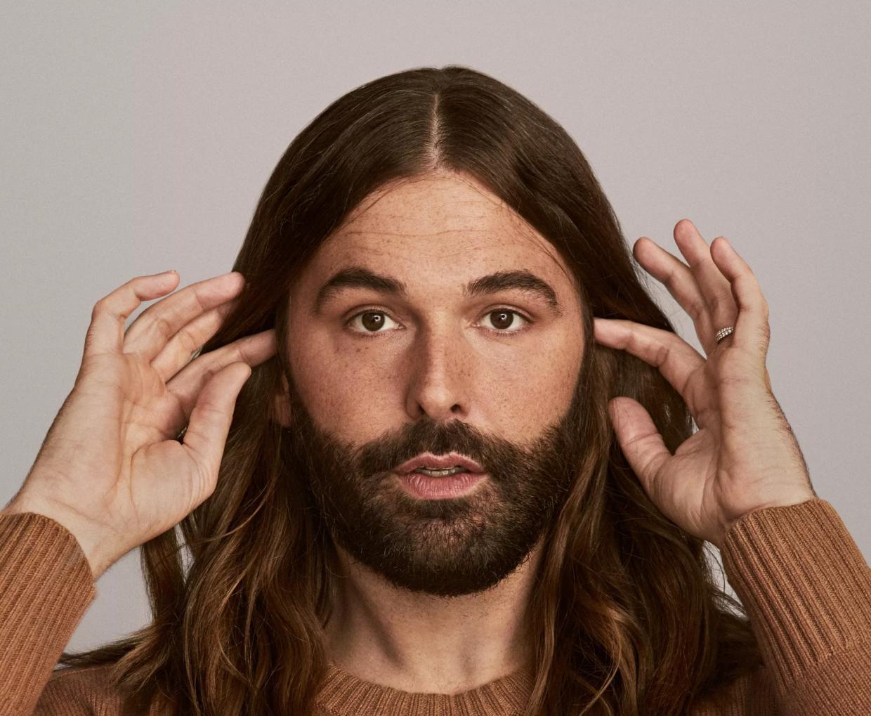 Jonathan Van Ness in a brown shirt