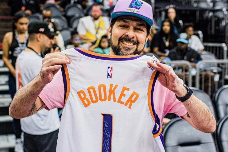 Henry Garcia with autographed Devin Booker jersey