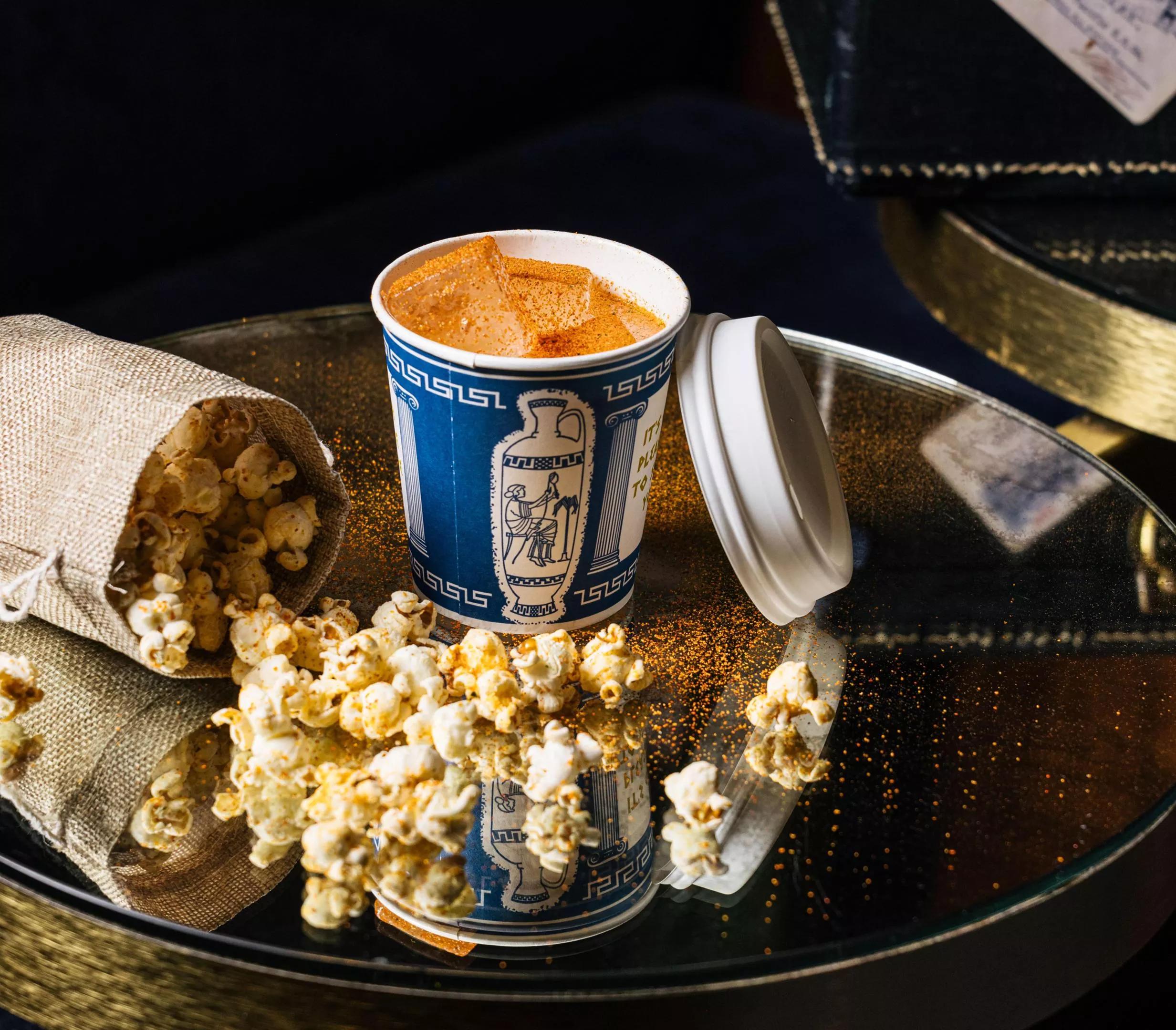 A cocktail and bag of popcorn from Platform 18.