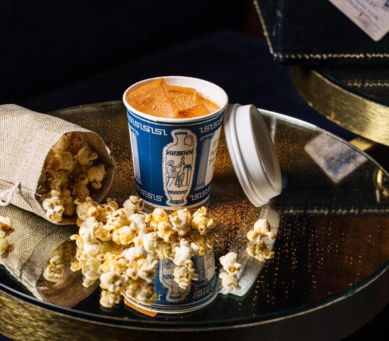 A cocktail and bag of popcorn from Platform 18.