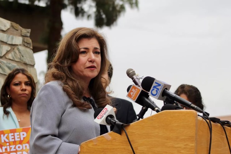 Mónica Villalobos speaks at podium