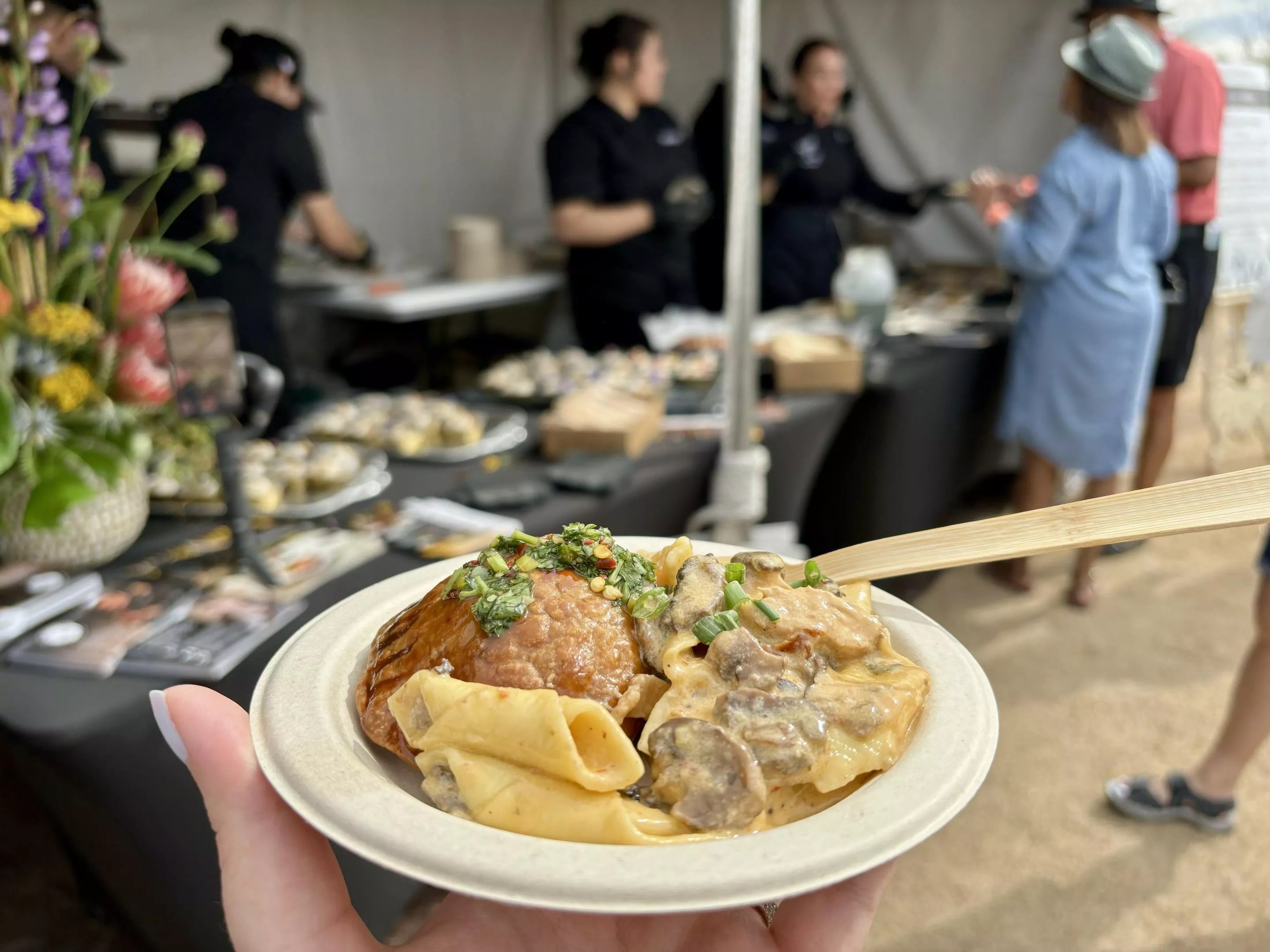 Plate of pasta with tent in the background.