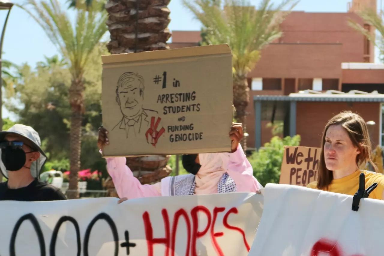 People holding signs at a protest.