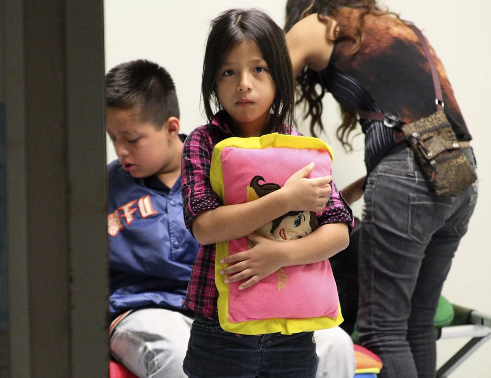 A young child clutches her pillow at a U.S. Customs and Border Protection facility.