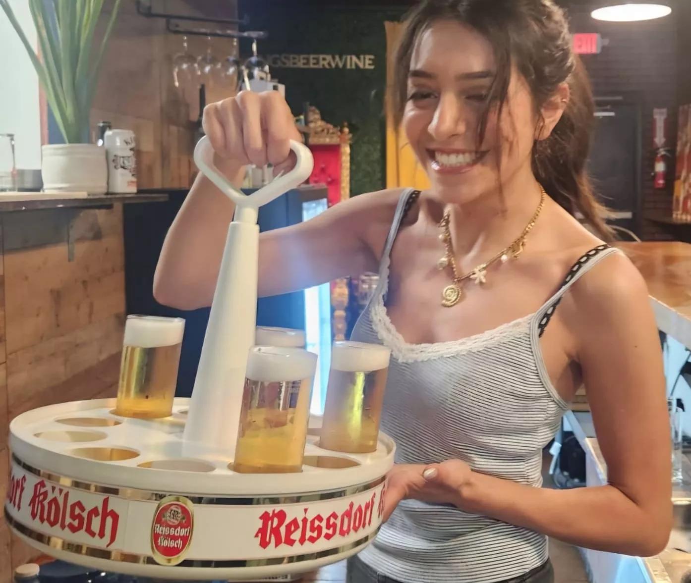 A server holding a tray of beer.