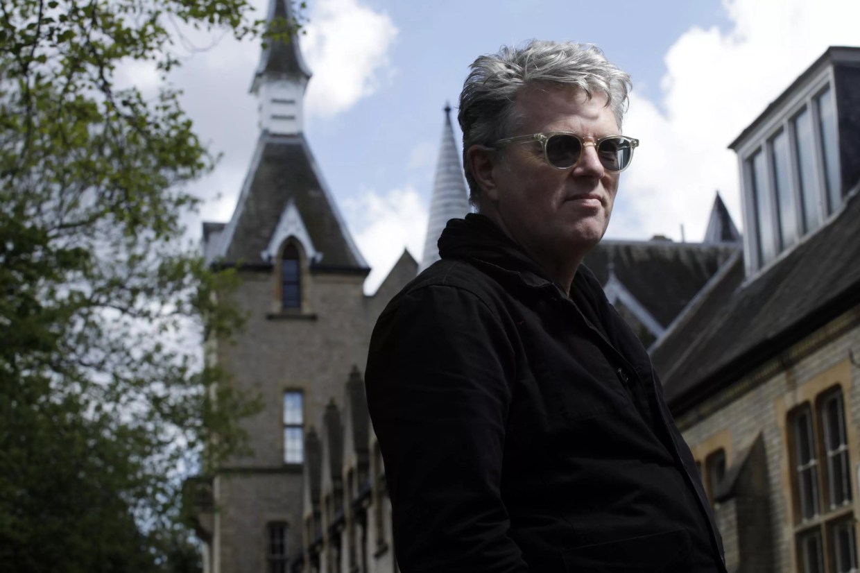 A man in sunglasses standing in front of a church.