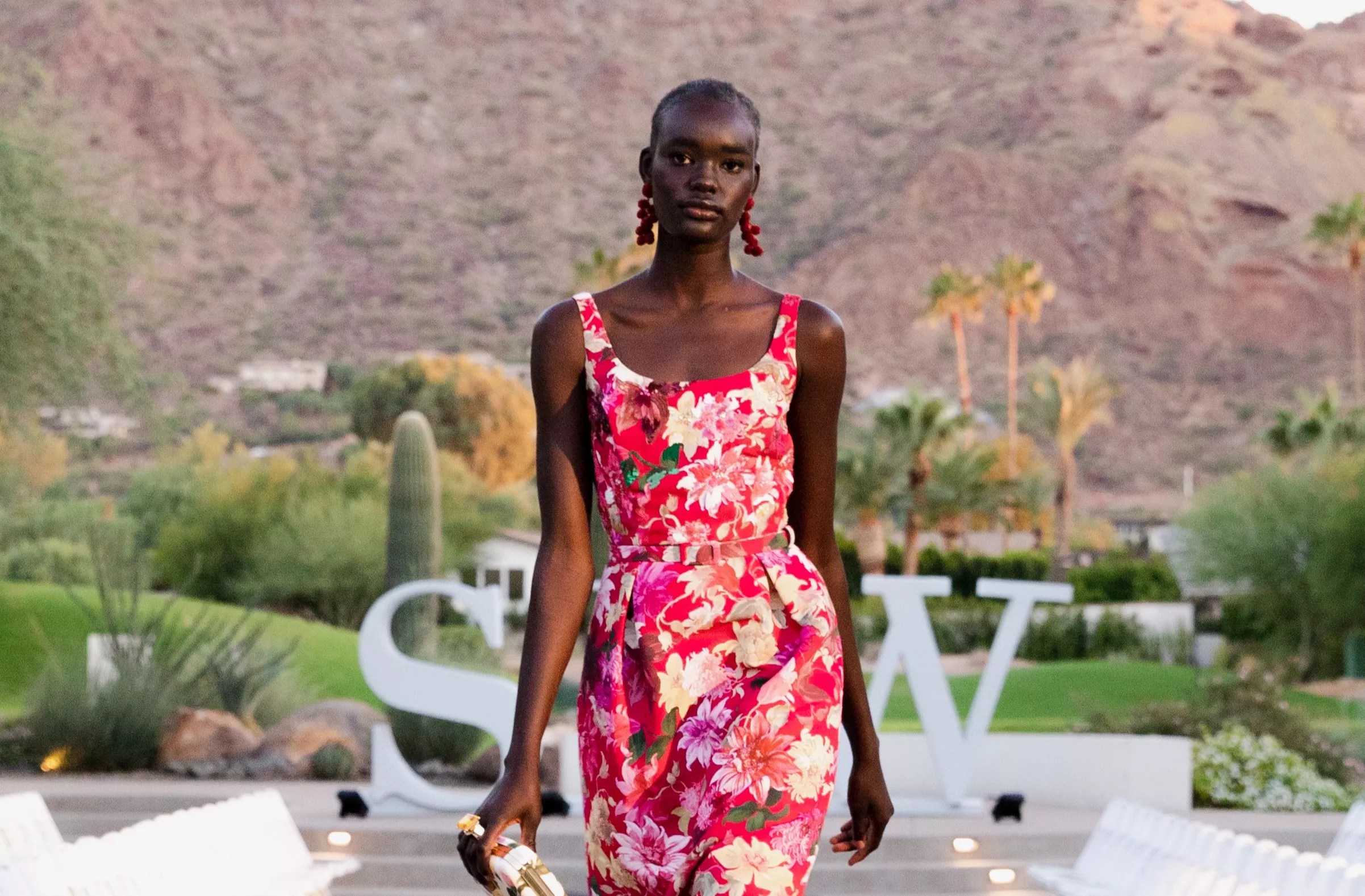A Black model posing in front of a mountain.