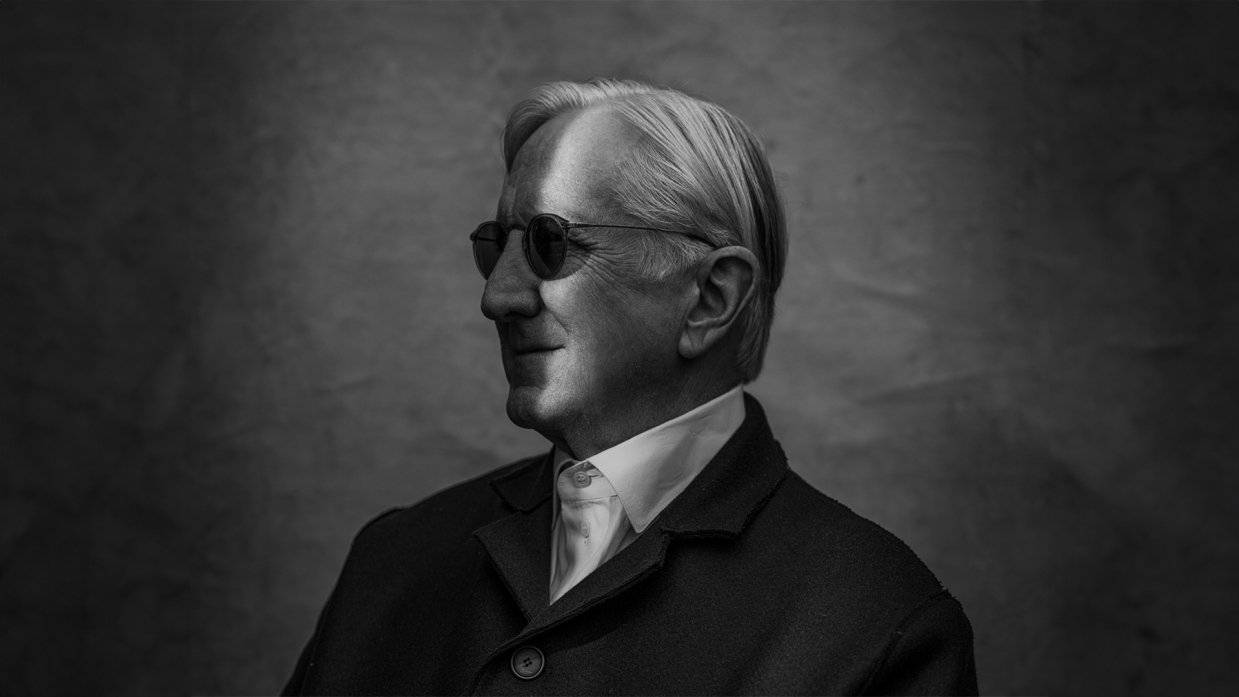 A portrait of an older man in black and white.