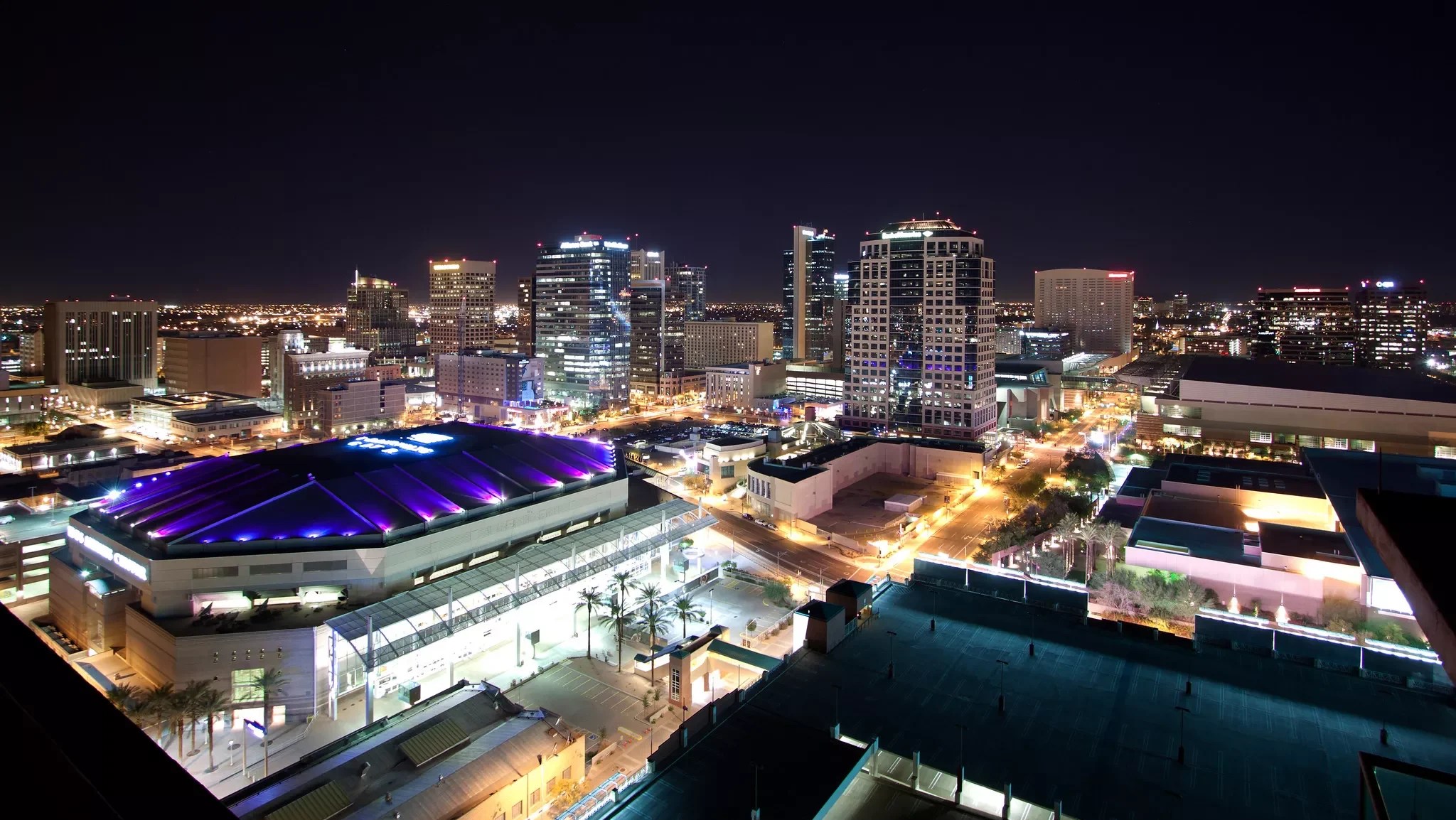 a nighttime photo of downtown Phoenix in 2012, featuring the Suns arena and Bank of America Tower.