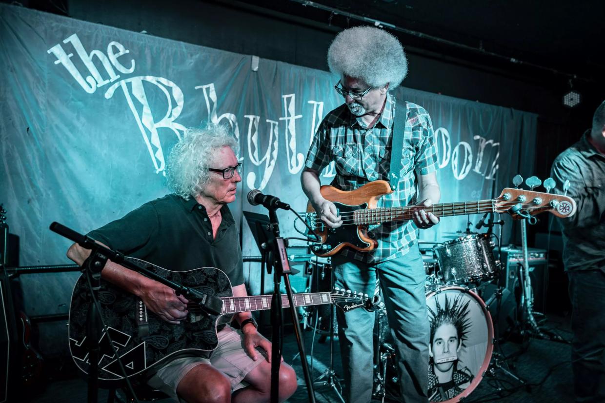 Two guitarists performing.