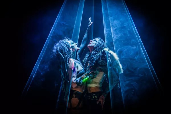 A woman and a man bathed in the spotlight.