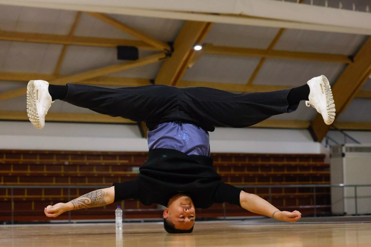A man break dancing on his head.