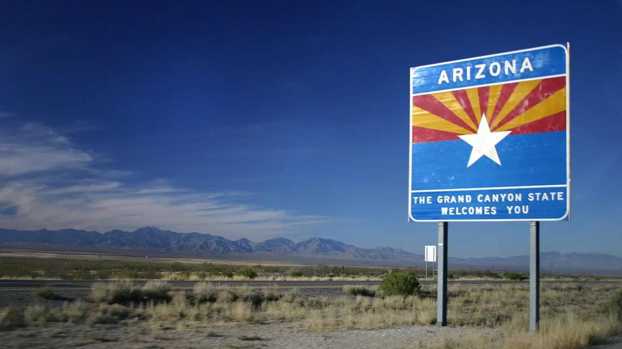 A "Welcome to Arizona" sign on the highway
