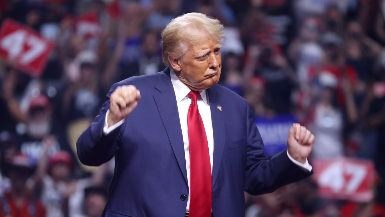 Donald Trump dances in front of a large crowd.