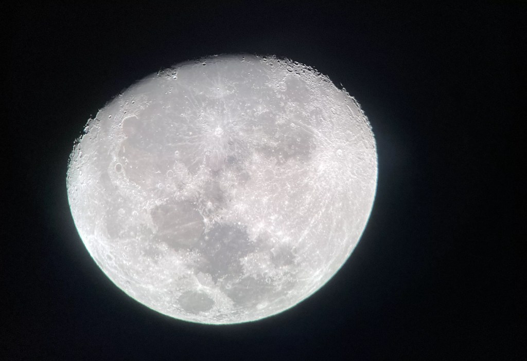 A photograph of the moon's surface at night.