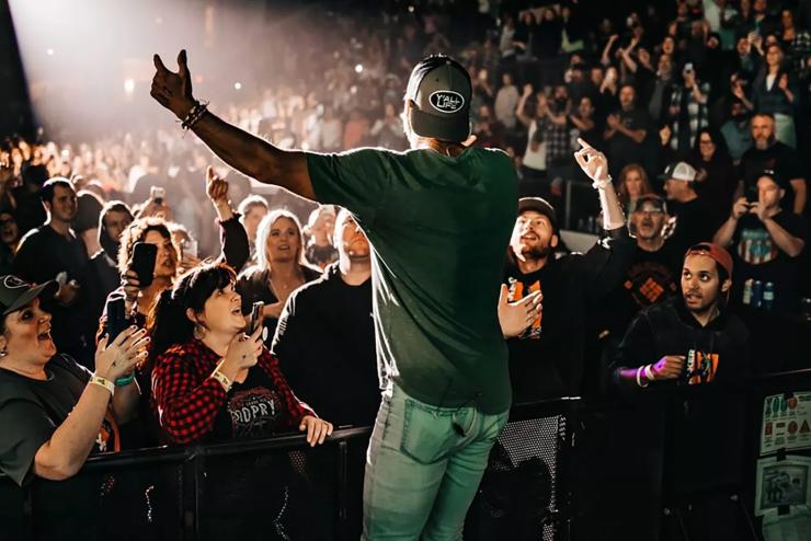 A male singer performs in front of a crowd.