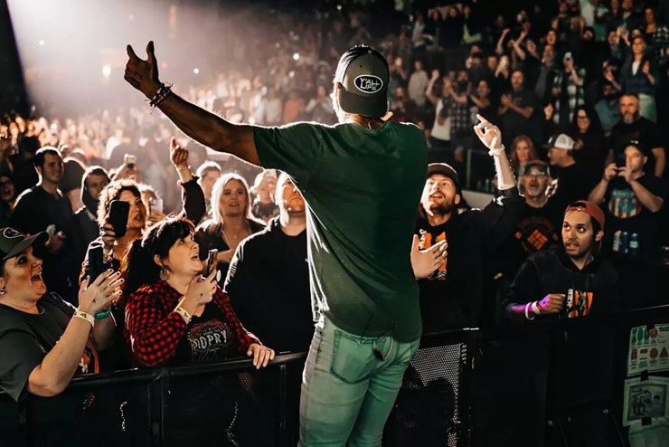 A male singer performs in front of a crowd.