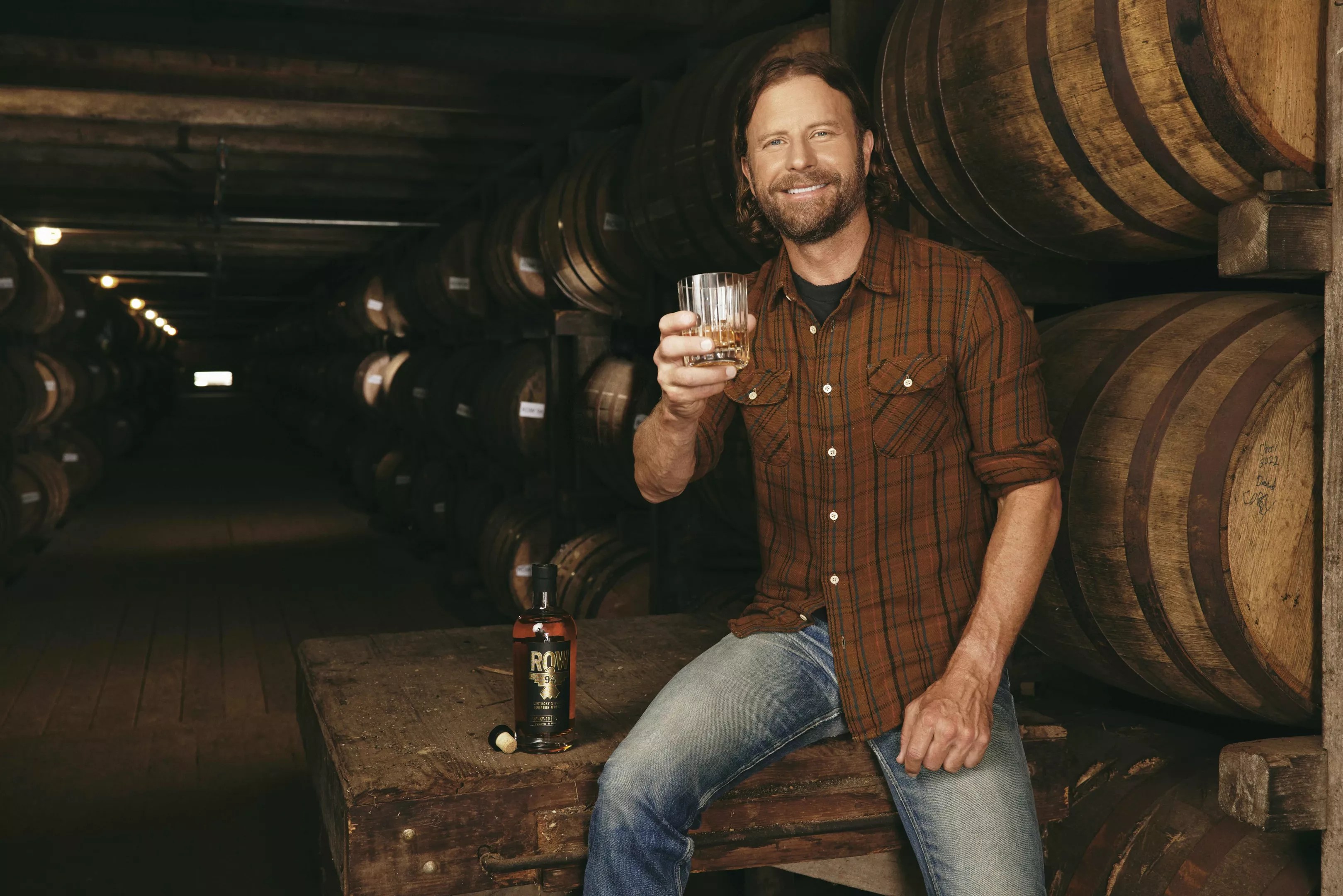 A man holding a glass of alcohol.