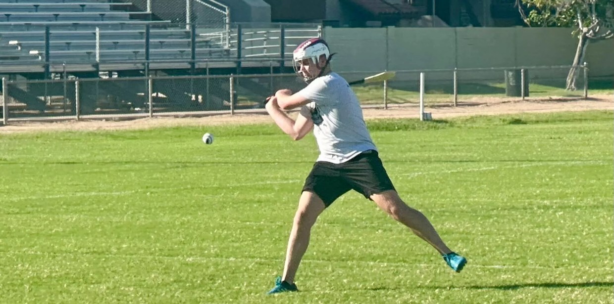 A man playing hurling.