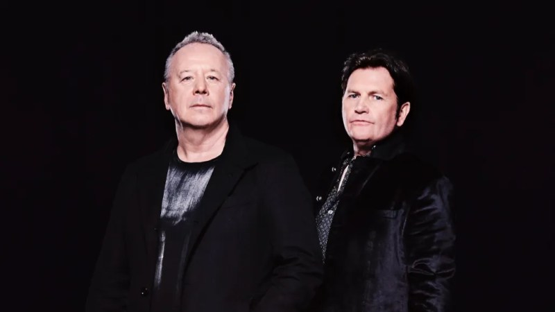 Two band members pose for picture.