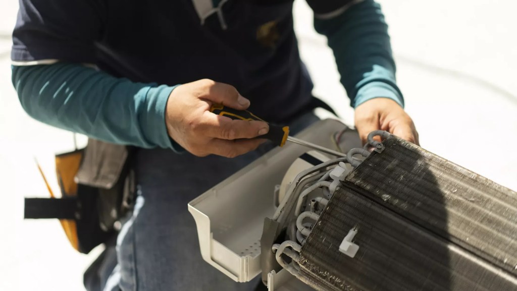 an HVAC repair person at work