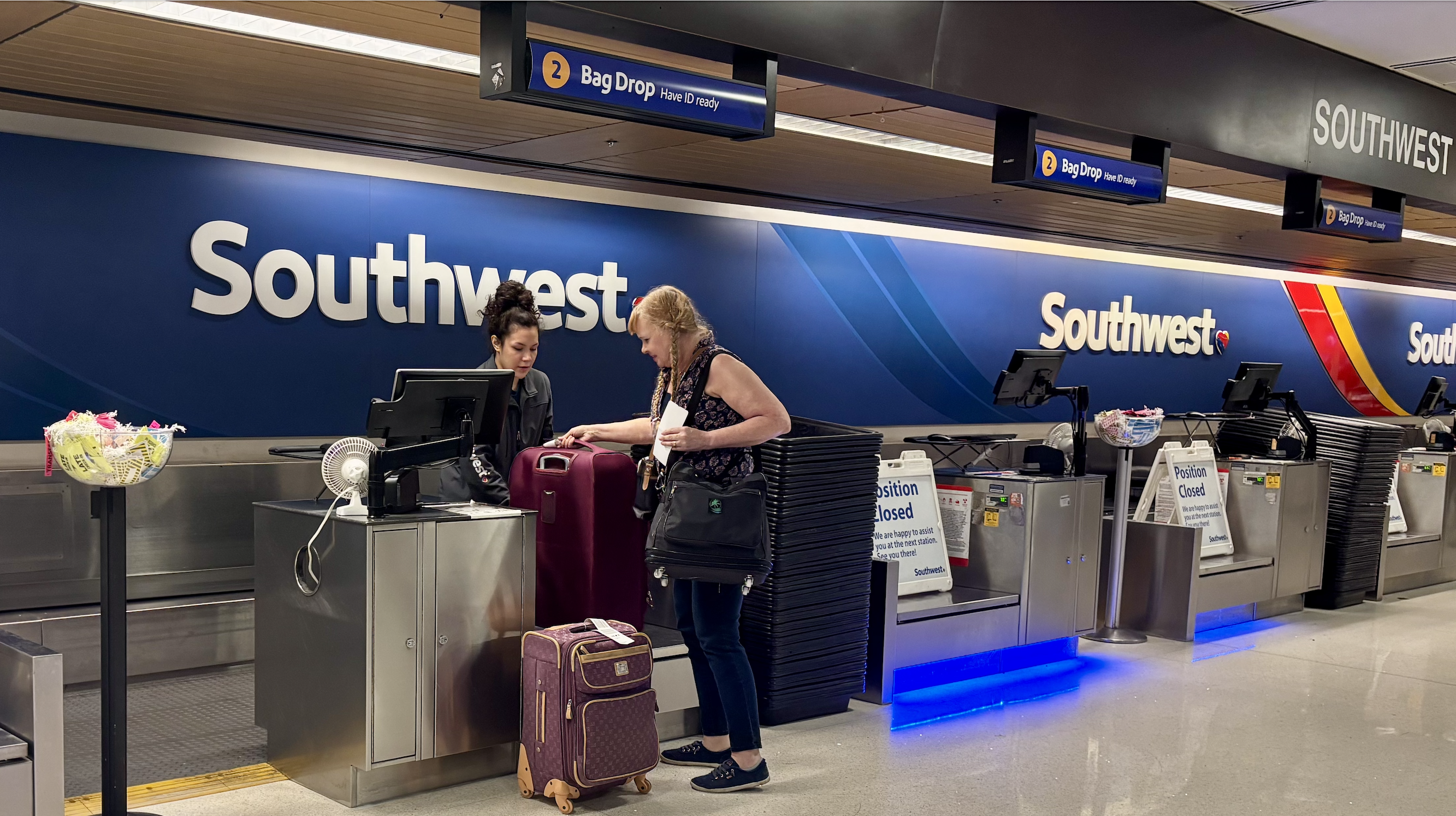 A woman checking bags at an airport.