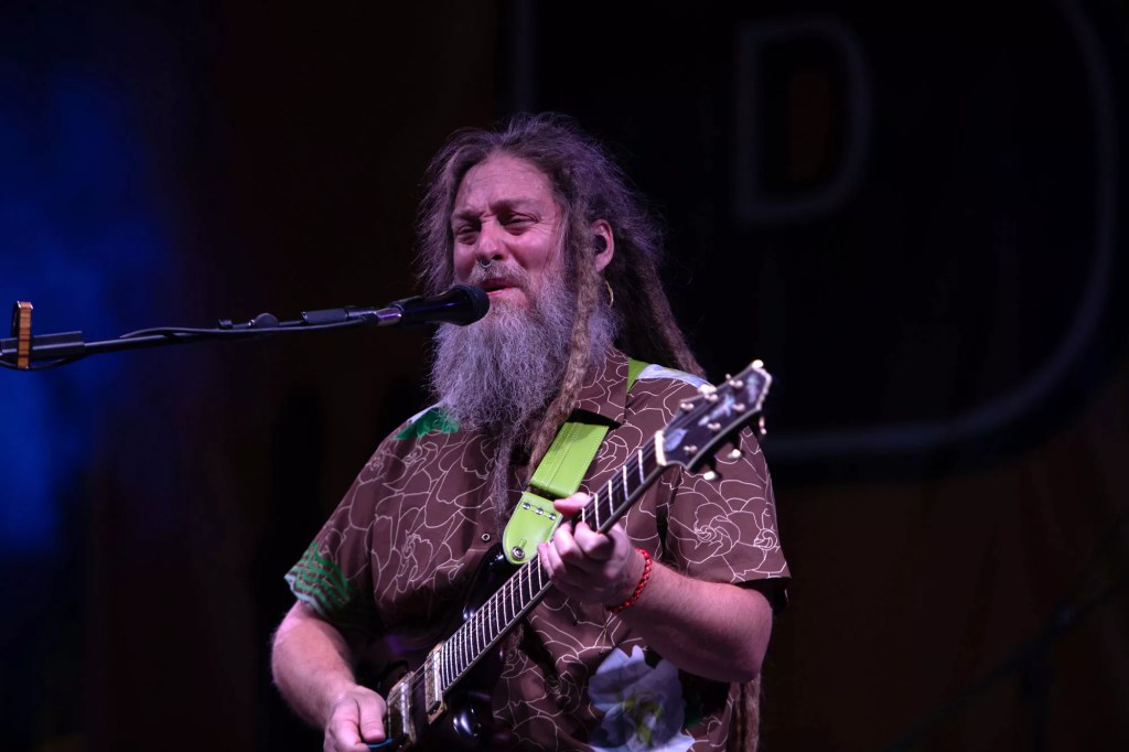 Mike Love plays guitar and sings