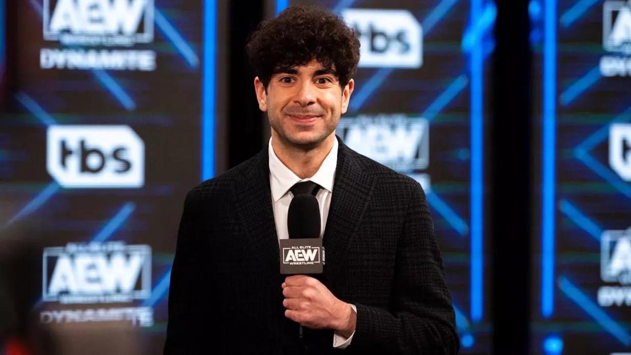 All Elite Wrestling co-owner and CEO Tony Khan holds a microphone during a broadcast of the company's television show AEW Dynamite.