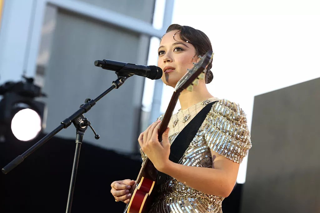 Woman with guitar performs