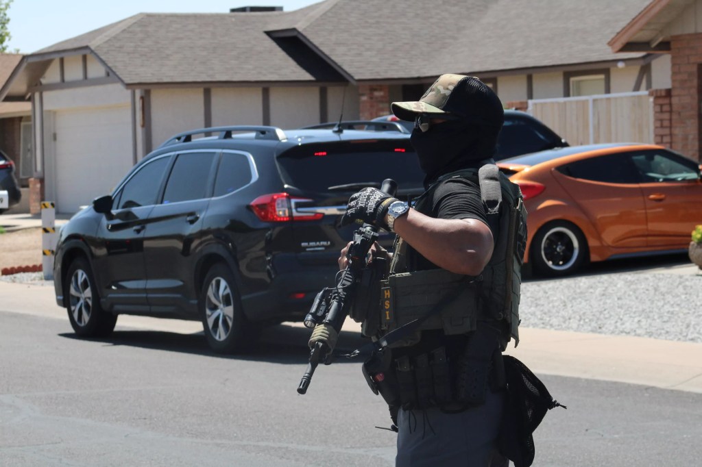 a masked HSI agent with a rifel