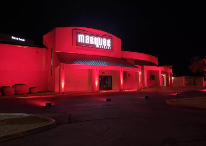 The exterior of Marquee Theatre in Tempe illuminated in red at night, with the venue's marquee sign glowing above the entrance.