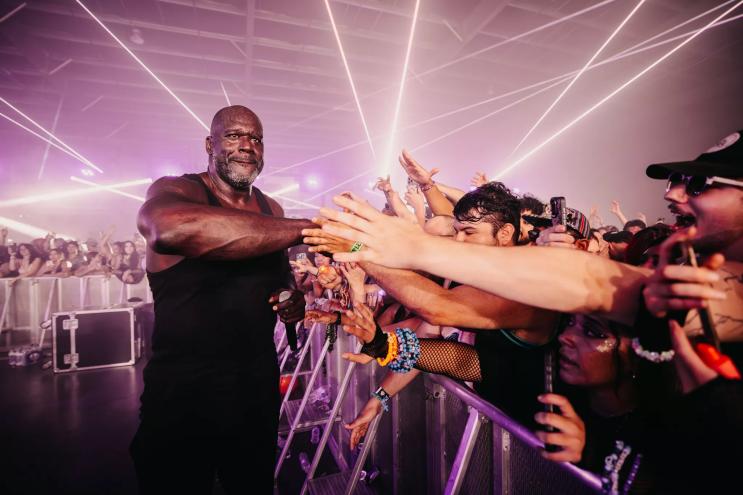 Shaquille O’Neal slaps the hands of fans in the crowd after performing as DJ Diesel in Chandler, Arizona in 2025.
