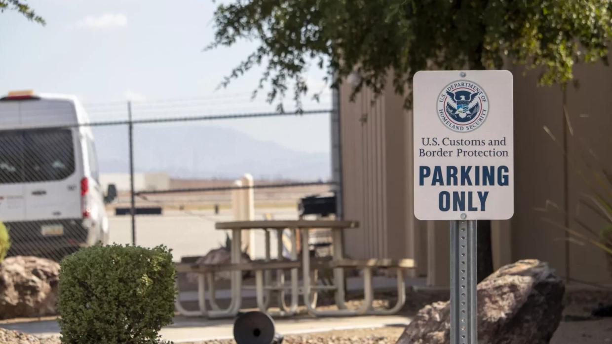 an customs and border protection parking sign in front of a building