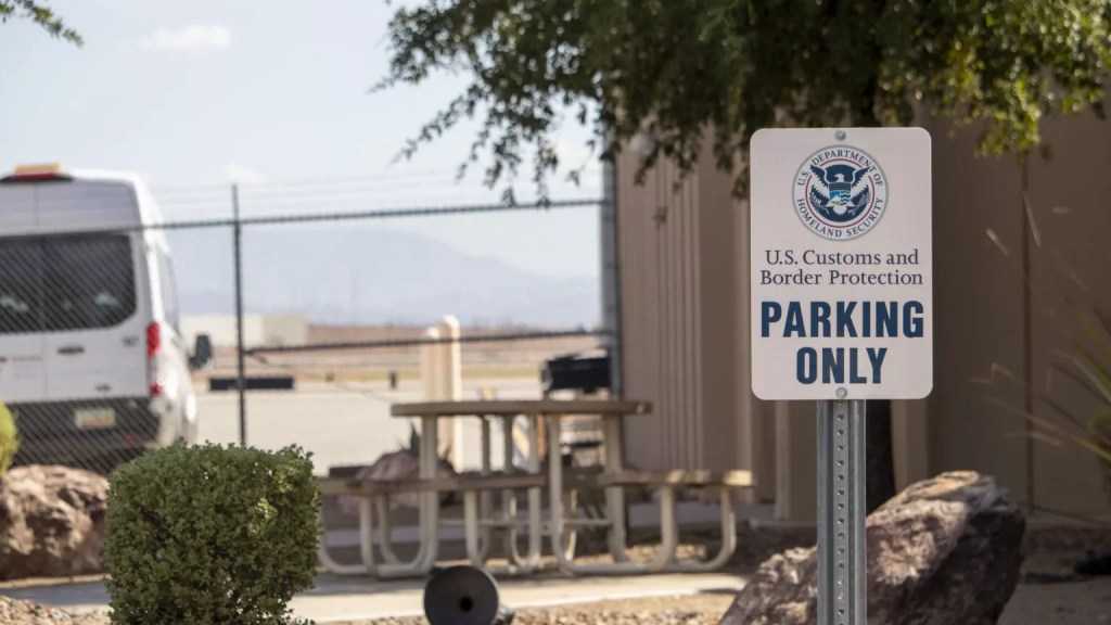 an customs and border protection parking sign in front of a building